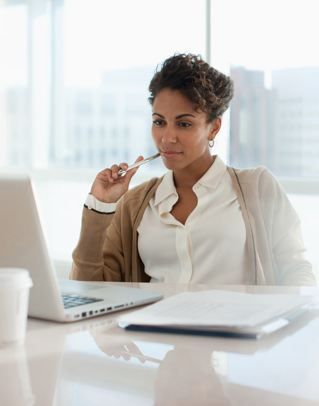 woman thinking and watching her computer